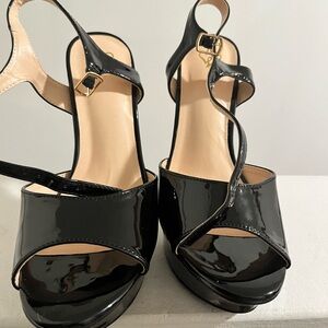 Black high heel shoes with strap around ankle